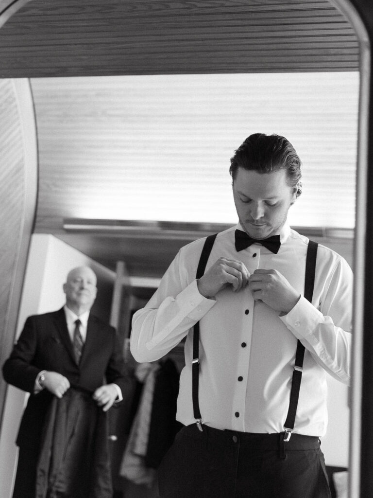 groom getting ready Michigan Micro-wedding on film in falling snow, Fennville MI