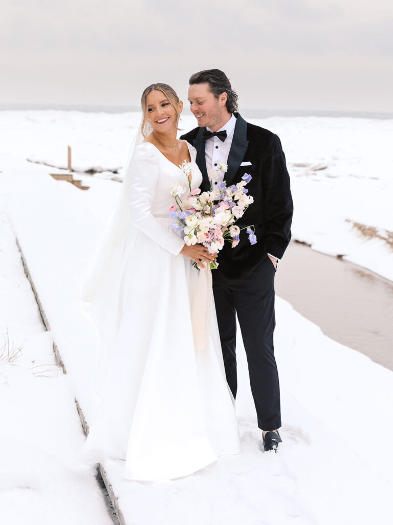Winter portrait of couple bundled together in soft light on 35mm film