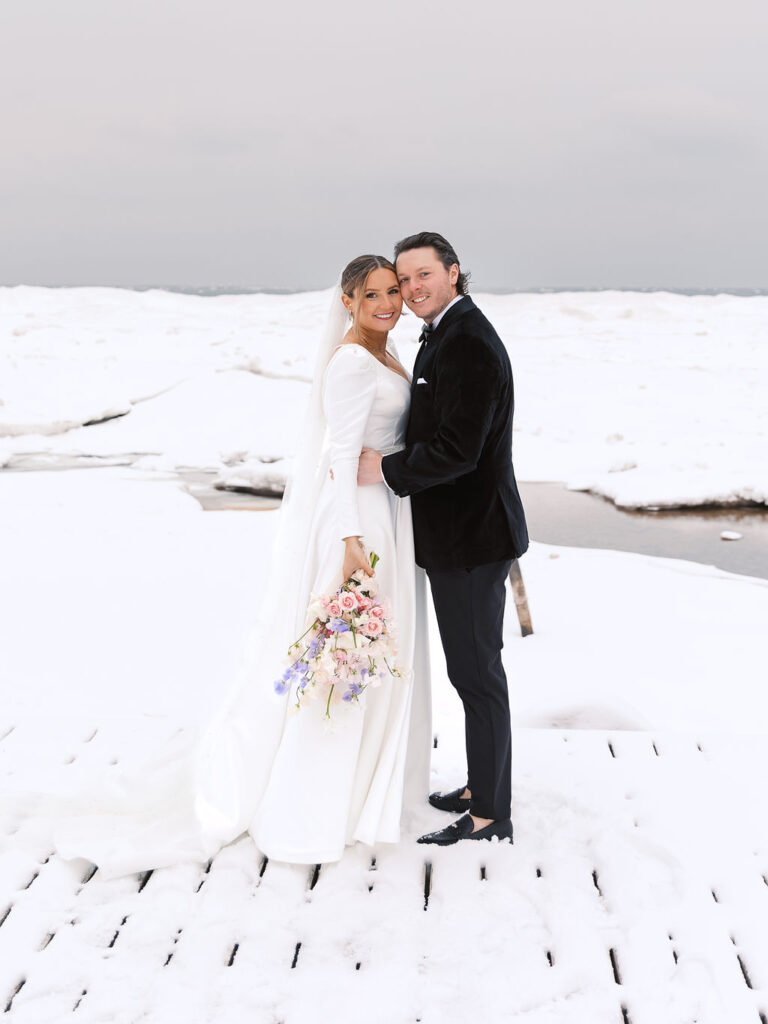 Winter portrait of couple bundled together in soft light on 35mm film