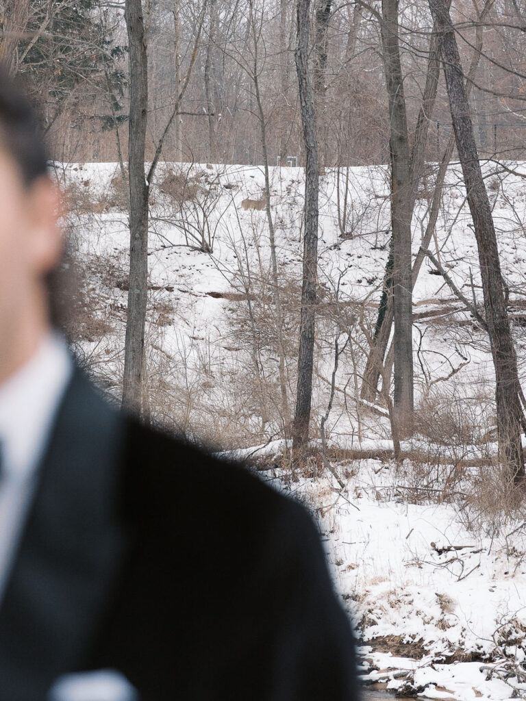 Final snowy portrait outside holding hands, winter micro-wedding film shot