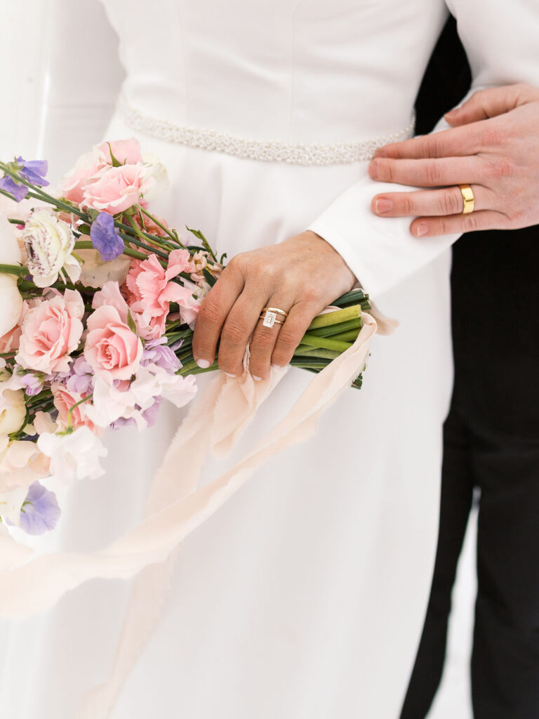 Final snowy portrait outside holding hands, winter micro-wedding film shot