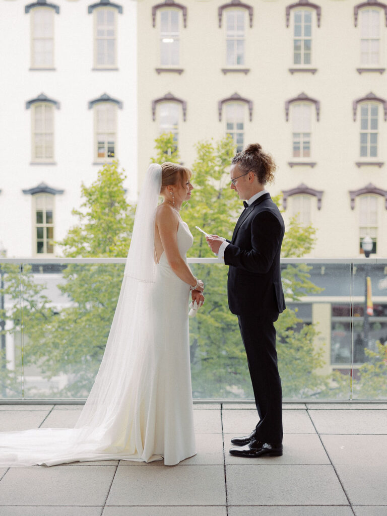 Elevated wedding party portrait in front of the Grand Rapids Art Museum steps