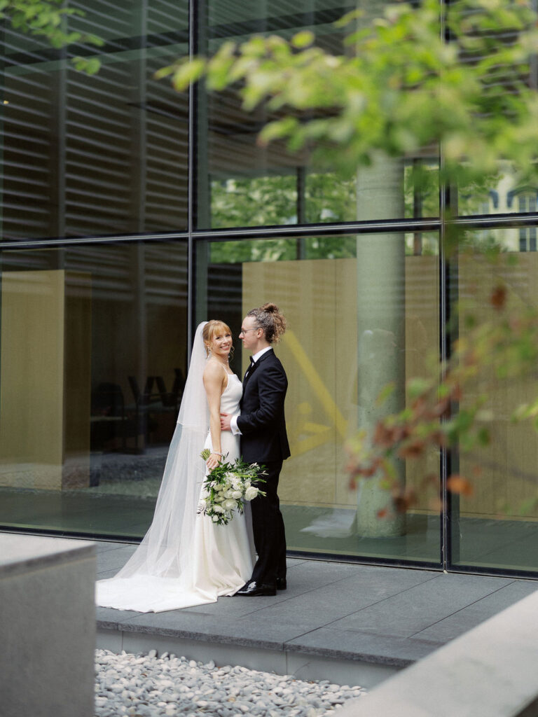 Elevated wedding party portrait in front of the Grand Rapids Art Museum steps