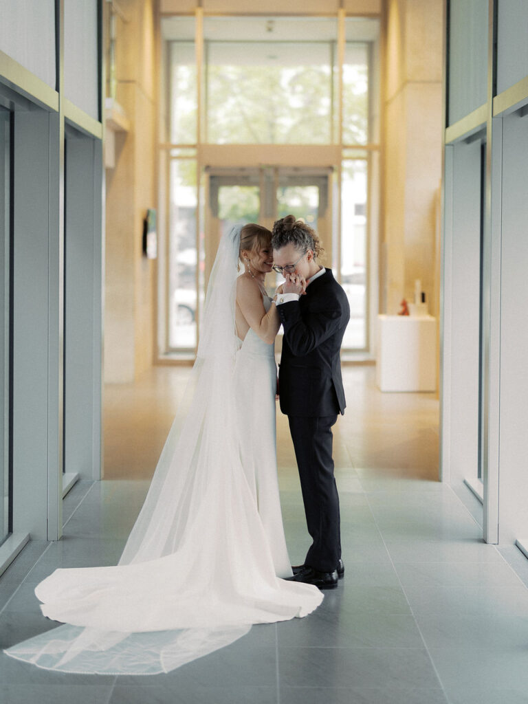 Elevated wedding party portrait in front of the Grand Rapids Art Museum steps
