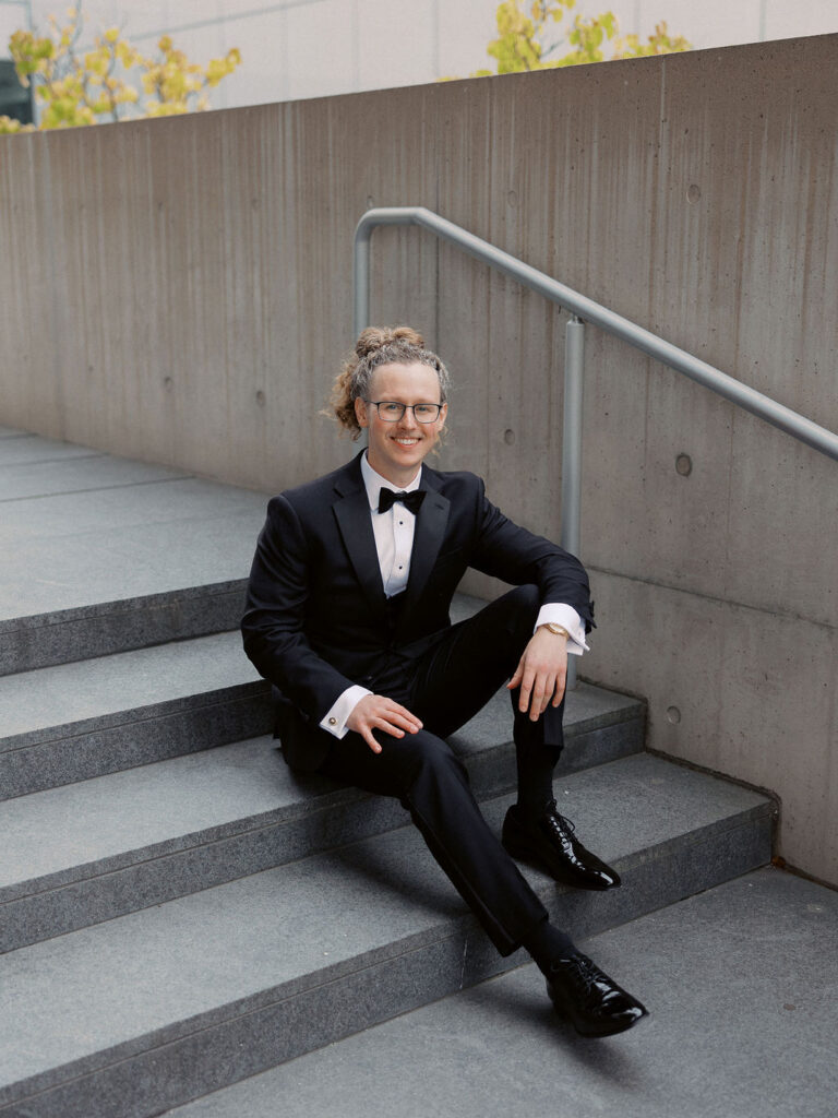 Elevated wedding party portrait in front of the Grand Rapids Art Museum steps