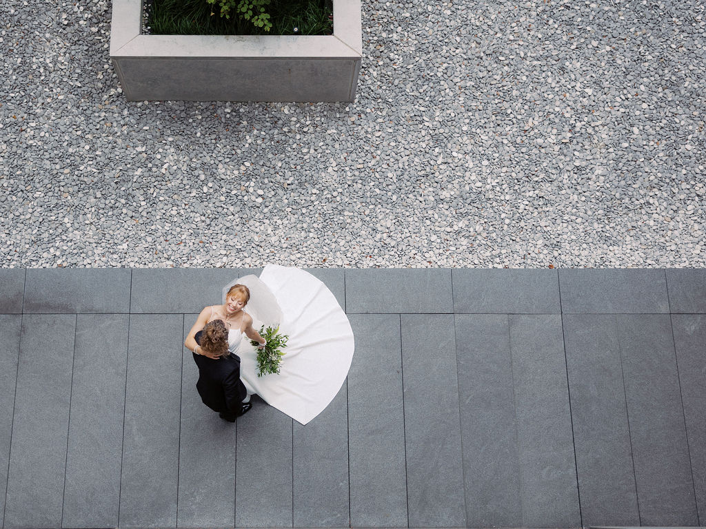 Elevated wedding party portrait in front of the Grand Rapids Art Museum steps