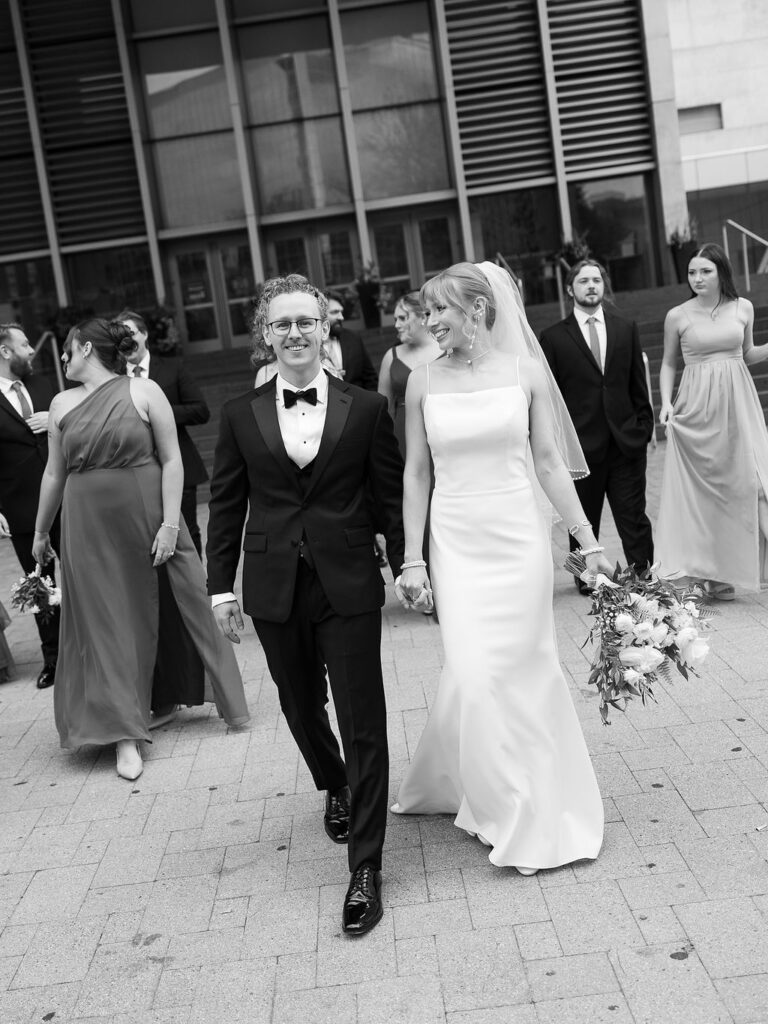 Elevated wedding party portrait in front of the Grand Rapids Art Museum steps