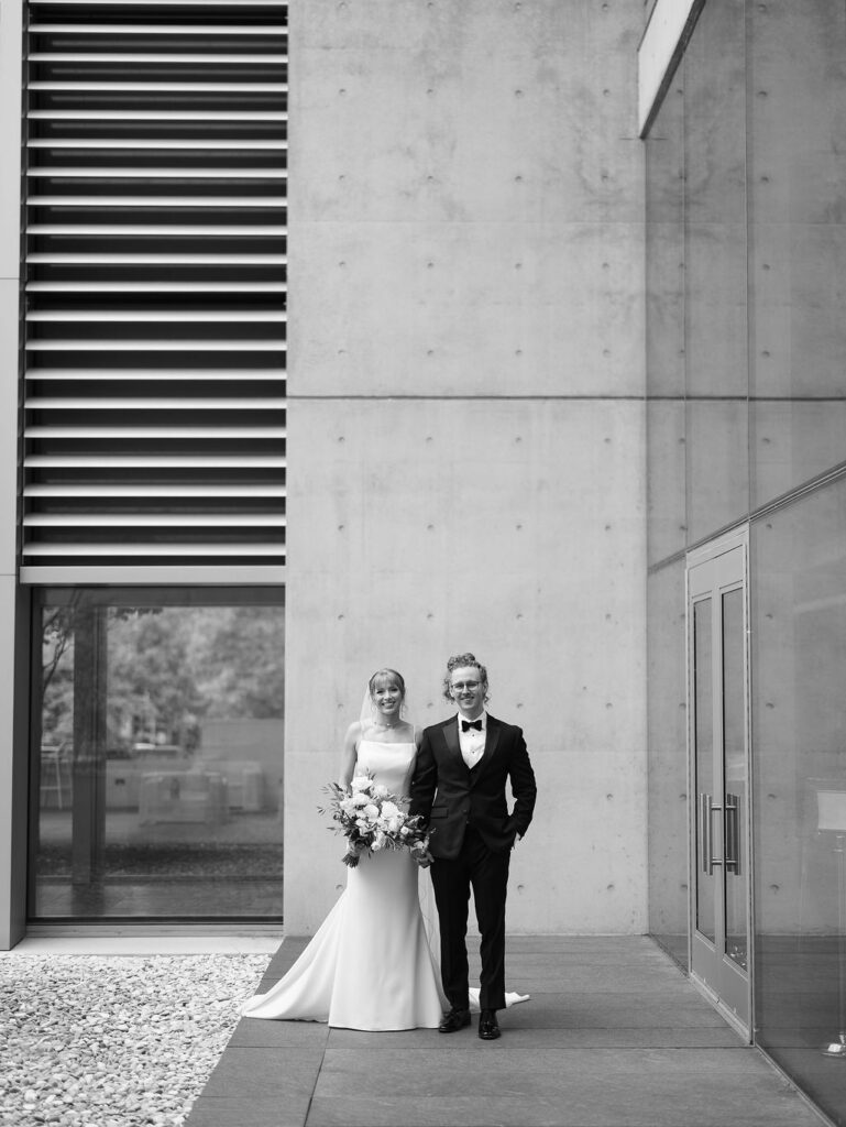Ceremony outside the Grand Rapids Art Museum with sleek modern floral design and natural light on film