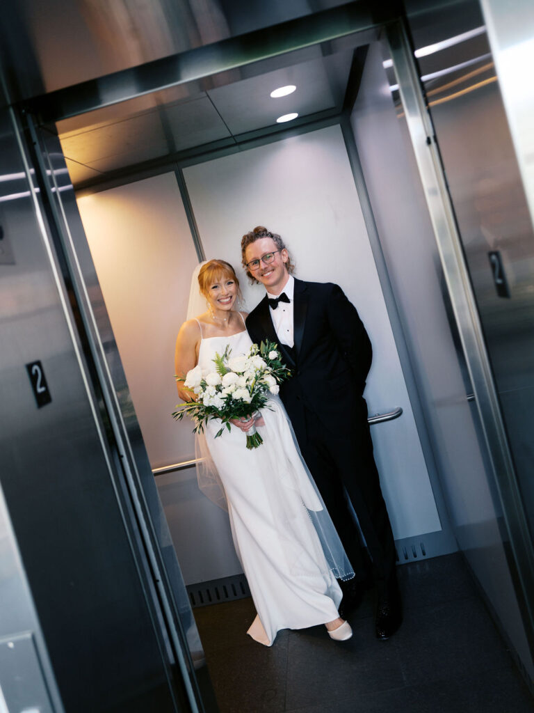 Ceremony outside the Grand Rapids Art Museum with sleek modern floral design and natural light on film