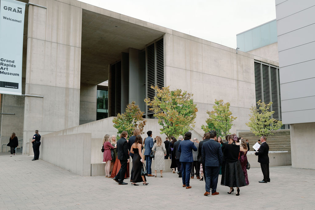 Ceremony outside the Grand Rapids Art Museum with sleek modern floral design and natural light on film