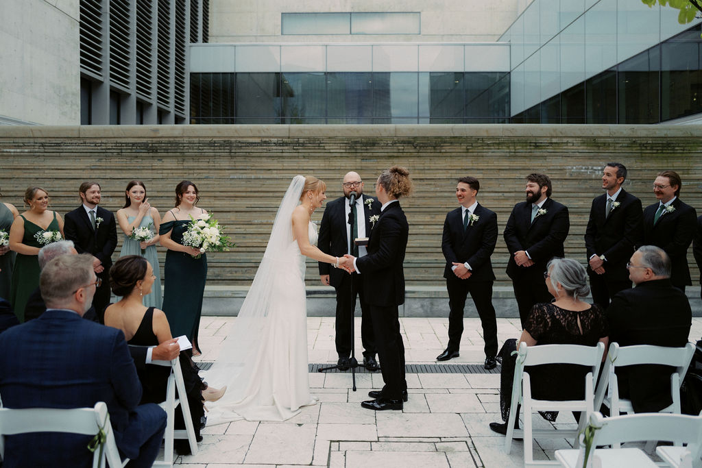 Ceremony outside the Grand Rapids Art Museum with sleek modern floral design and natural light on film