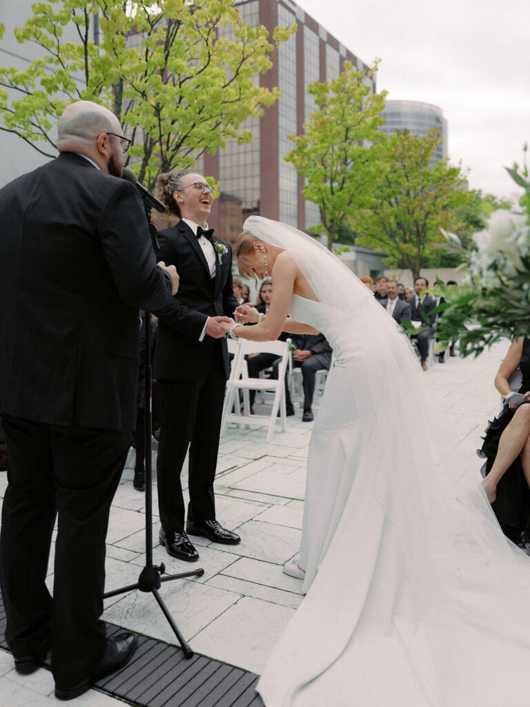 Ceremony outside the Grand Rapids Art Museum with sleek modern floral design and natural light on film
