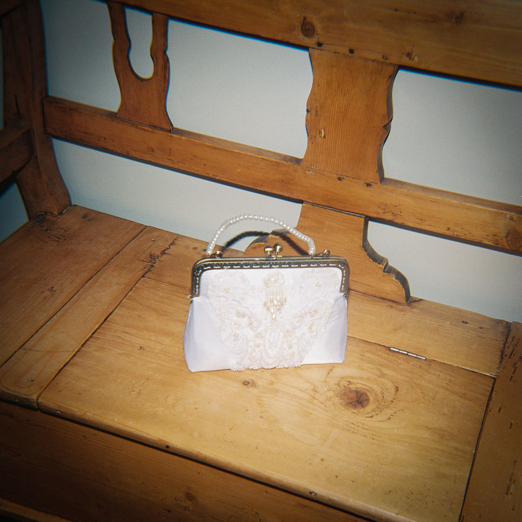 Elegant outdoor reception tablescape with candles and classic florals on film