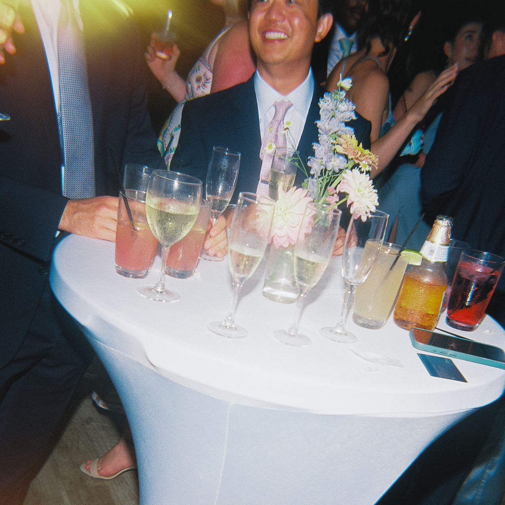Elegant outdoor reception tablescape with candles and classic florals on film