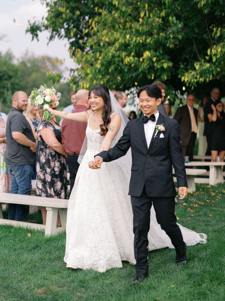 Of the Land Wedding Photos in Michigan on film, joyful celebration with lush florals and bride and groom laughing