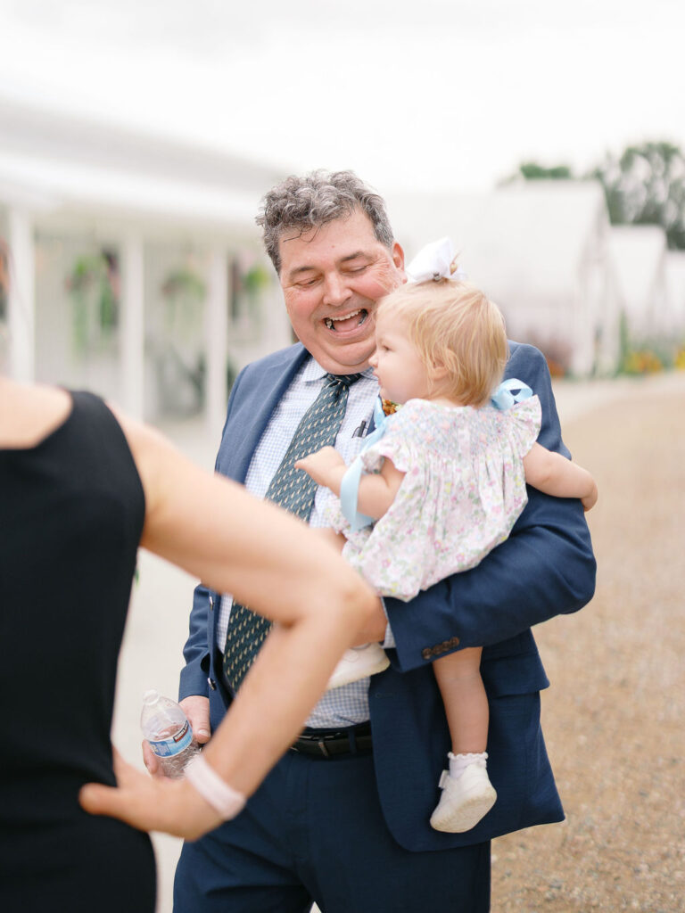 Of the Land Wedding Photos in Michigan on film, joyful celebration with lush florals and bride and groom laughing